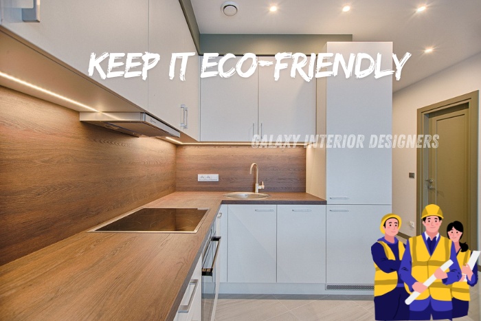 Eco-friendly modular kitchen with sleek white cabinets, wooden countertops, and energy-efficient lighting, designed by Galaxy Interior Designers, Chennai