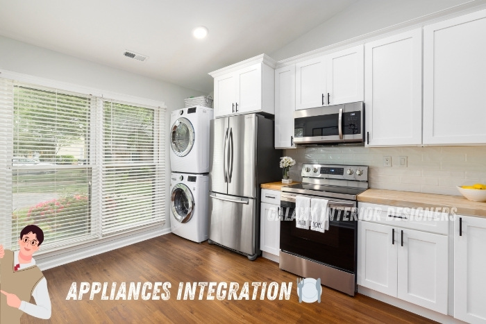 Modern kitchen with integrated appliances including a stainless steel refrigerator, oven, microwave, and stacked washer-dryer. Ideal for efficient and stylish living in Chennai homes. Enhance your kitchen with Galaxy Interior Designers' expert appliance integration services