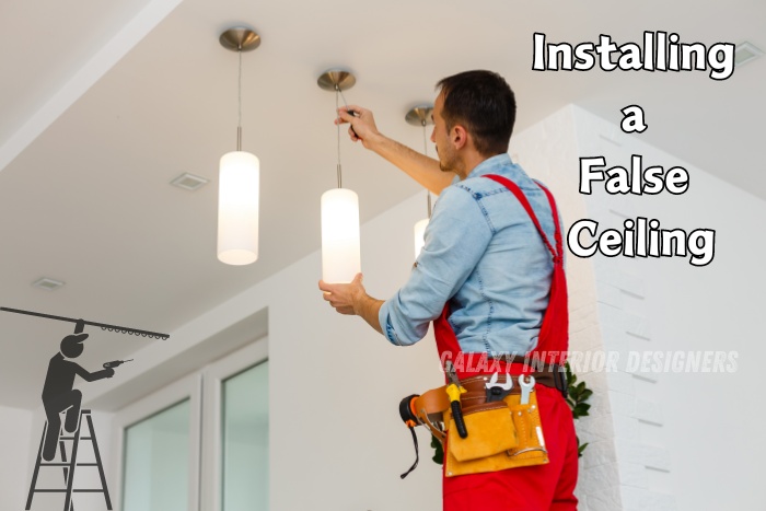 Professional installing a false ceiling with modern pendant lights in a Chennai home. Enhance your living space with expert false ceiling installations by Galaxy Interior Designers.