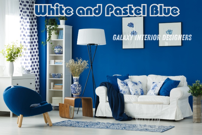 Elegant white and pastel blue living room by Galaxy Interior Designers in Chennai. The design features a cozy white sofa with blue and white throw pillows, a stylish blue accent wall, and a comfortable blue armchair